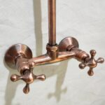 Copper indoor and outdoor shower system featuring high pressure.