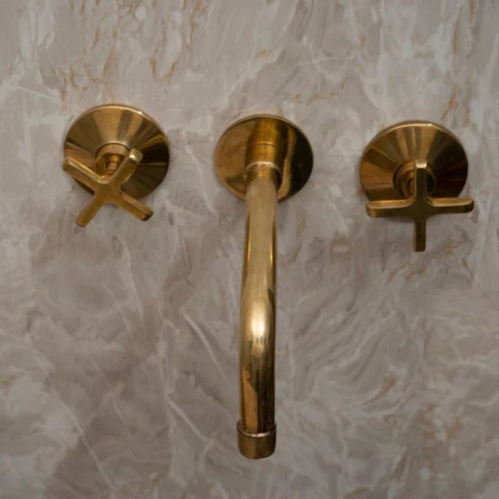 Wall mounted bath faucet in unlacquered brass