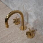 Bring the Industrial Look to Your Bathroom with This Widespread Unlacquered Brass Faucet
